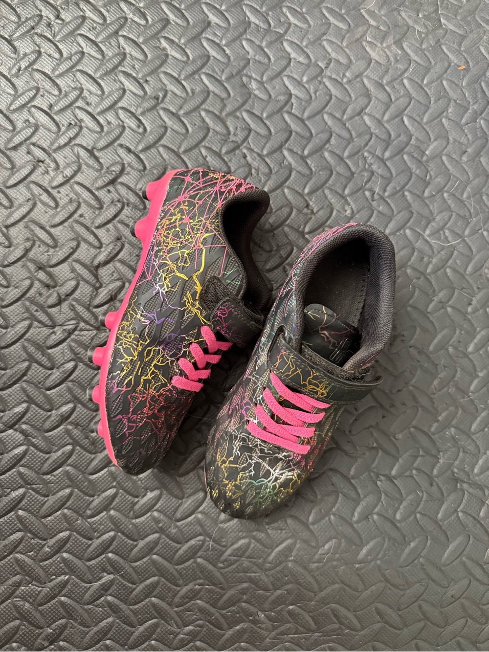 Kids Black Athletic Cleats with Neon Paint-Splatter and Pink Accents